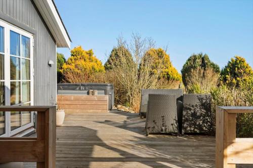 a patio with two chairs and a house at LF11104-Struer-Tranebaervej-4 in Struer