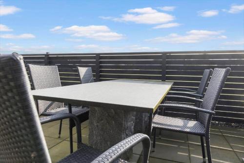 a table and chairs on top of a balcony at LF12006-Handbjerg-Runddelen-6 