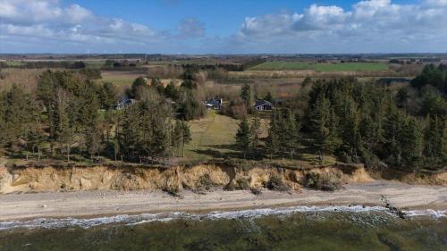 an aerial view of a house on a hill next to a river at LF14132-Spottrup-Porfyrvej-2 in Spottrup