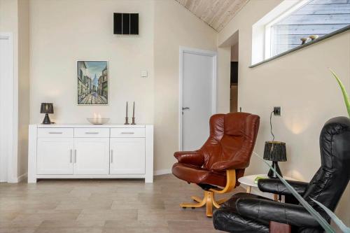 a living room with a chair and a table at LF14344-Roslev-Folvigvej-44 in Roslev