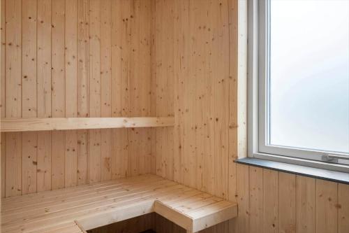 a sauna with a bench in a wooden wall at LF14344-Roslev-Folvigvej-44 in Roslev