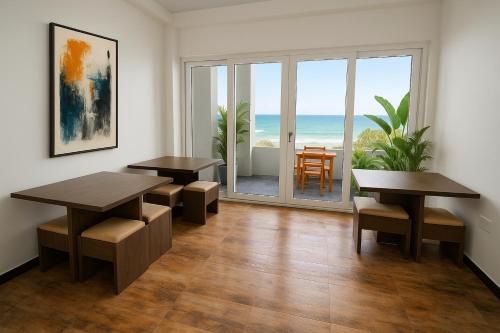 a dining room with tables and a view of the ocean at Goalie Beachfront Resort in Hikkaduwa