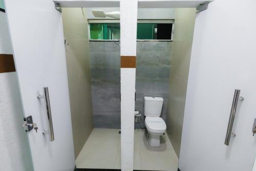 a bathroom with a toilet and a shower stall at torre forte apart hotel in Rio Branco