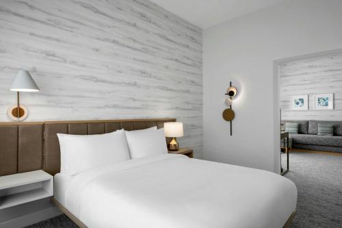 a bedroom with a white bed and a couch at TownePlace Suites by Marriott Midwest City in Del City
