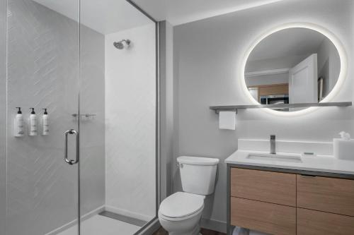a bathroom with a shower and a toilet and a sink at TownePlace Suites by Marriott Midwest City in Del City