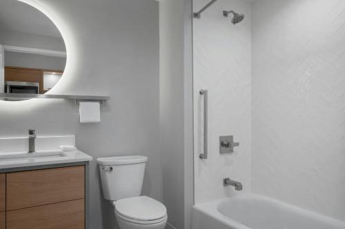 a white bathroom with a toilet and a sink at TownePlace Suites by Marriott Midwest City in Del City