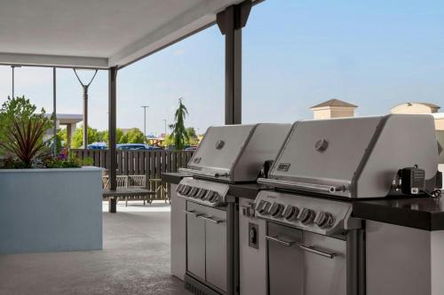a row of grill equipment on a patio at TownePlace Suites by Marriott Midwest City in Del City