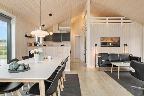 a dining room and living room with a table and chairs at OH419-Hadsund-Halvrebene-60 in Hadsund