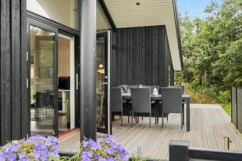 a dining area with a table and chairs on a patio at OH419-Hadsund-Halvrebene-60 in Hadsund
