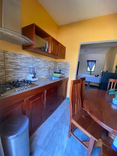 a kitchen with a wooden table and a dining room at Jungla maya hotel in Bacalar