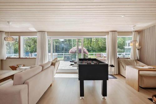 a living room with a foosball table in the middle of the room at OH518-Hadsund-Kaeragervej-13 in Hadsund