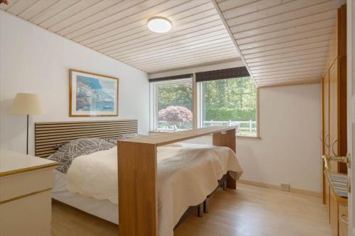 a bedroom with a bed with a desk in it at OH518-Hadsund-Kaeragervej-13 in Hadsund