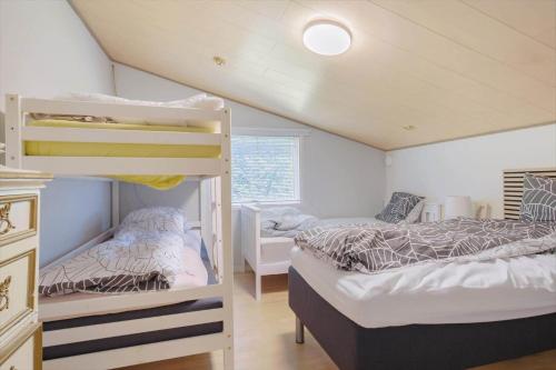 a bedroom with two bunk beds and a window at OH518-Hadsund-Kaeragervej-13 in Hadsund