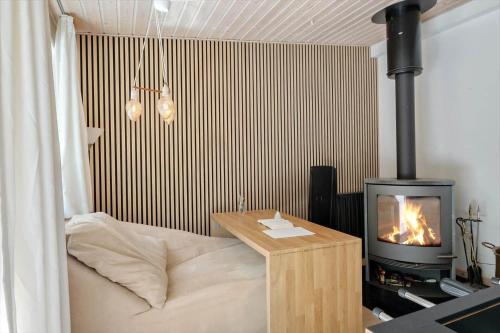 a bedroom with a bed with a fireplace in it at OH518-Hadsund-Kaeragervej-13 in Hadsund