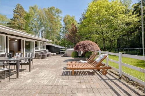 a patio with two benches and a table and chairs at OH518-Hadsund-Kaeragervej-13 in Hadsund