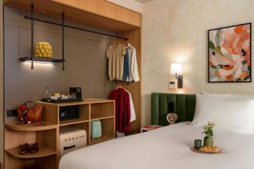 a hotel room with a bed and a closet at Salitre Hotel, Sonder by Marriott Bonvoy in Málaga
