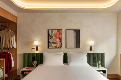 a bedroom with a large white bed with green accents at Salitre Hotel, Sonder by Marriott Bonvoy in Málaga