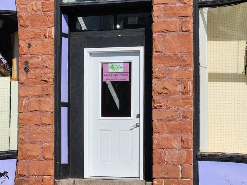 a white door in a brick building with a sign on it at K5 2nd Floor Studio Near MTU, Keweenaw, Great Rates 