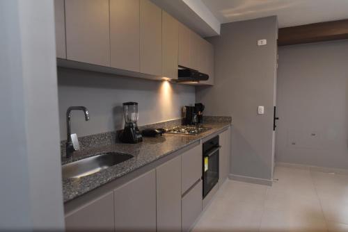 a kitchen with a sink and a counter top at Encanto 16 - Apartamento moderno y lujoso in Ibagué