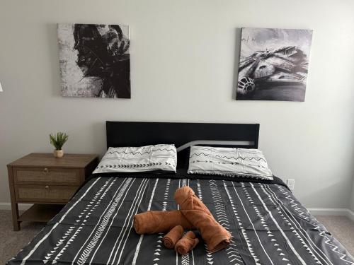 a stuffed teddy bear laying on a bed at NEW HOUSE! 4BR Entire house Near Airport in Savannah