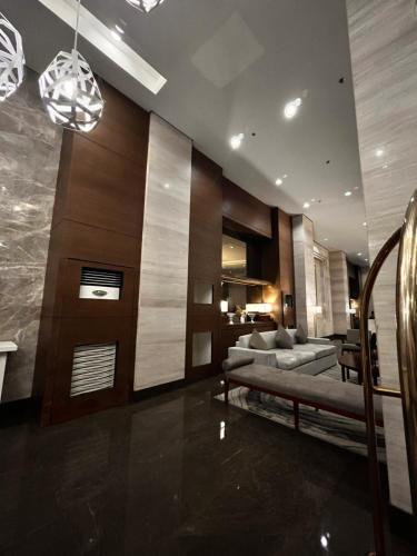 a living room with a couch and a bed in it at Radiance Manila Bay Bayview Comfort with Pool & Pet-Friendly in Manila