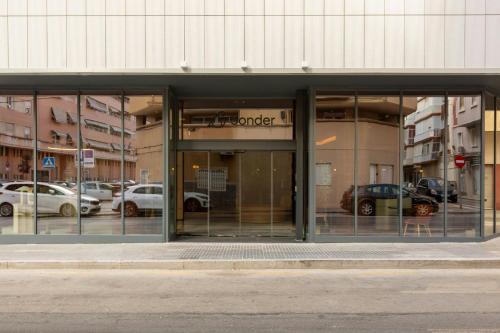 a store front with glass doors and cars in a parking lot at Salitre Hotel, Sonder by Marriott Bonvoy in Málaga
