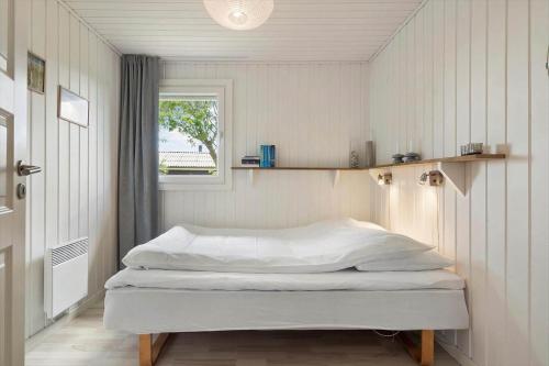a bed in a room with a window at OH291-Hadsund-Mollevaenget-16 in Hadsund