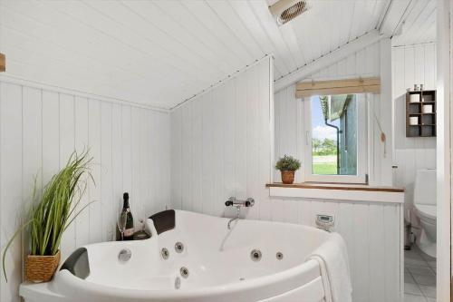 a white bathroom with a tub and a toilet at OH291-Hadsund-Mollevaenget-16 in Hadsund