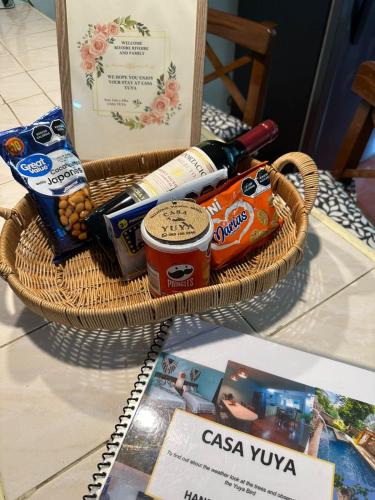 a basket filled with food and drinks on a table at Casa Yuya in Valladolid