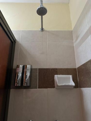 a bathroom with a book shelf and a light at Casa Yuya in Valladolid