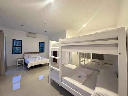 a room with two bunk beds and a bed at Villa Bella in Puerto Princesa City