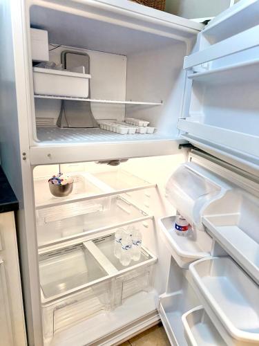 an open refrigerator with its door open at Pristine Full Sized Montrose Apartment Half Block to Menil Museum in Houston