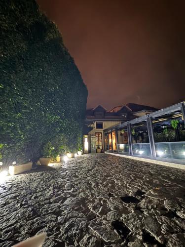 a night view of a building with a stone road at Hotel Marabella in Sibiu