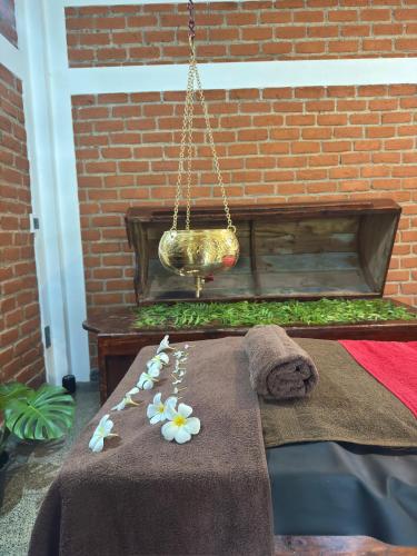 a table with flowers on top of a blanket at Nivartana Villa and Purana Ayurveda Center in Bentota