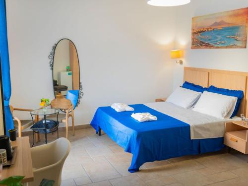 a bedroom with a bed and a table and a mirror at Sea VIBES II FLOOR in Portici