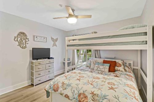 a bedroom with a bunk bed and a television at Spa On Port Royal Sound 3337 in Hilton Head Island