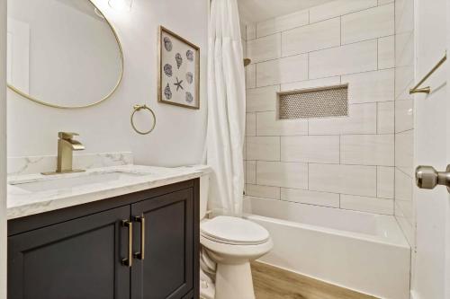 a bathroom with a sink and a toilet and a tub at Spa On Port Royal Sound 3337 in Hilton Head Island