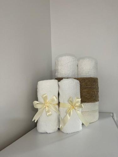 a stack of towels with bows on a shelf at Golden House Berat in Berat