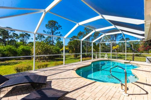 a swimming pool under a clear tent with a swimming poolvisor at Fishing in Paradise in Saint James City