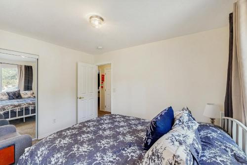 a bedroom with a bed with blue and white pillows at Algo Bien in Chiloquin