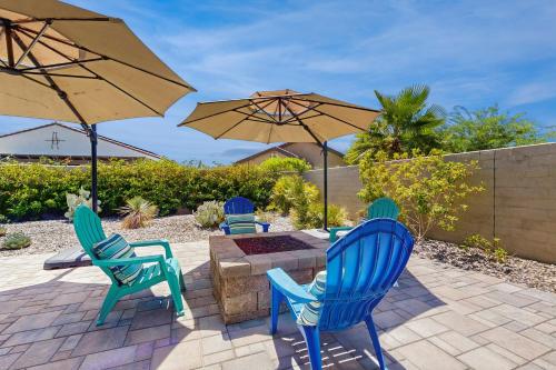 a patio with four chairs and a table and umbrellas at Sundance Retreat in Rancho Mirage