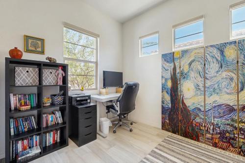 an office with a desk and a large painting on the wall at Sundance Retreat in Rancho Mirage