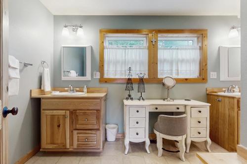 a bathroom with a sink and a desk with a mirror at Tranquil Shores Hideaway in Cle Elum