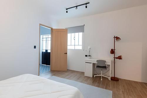 a bedroom with a bed and a desk and a mirror at Casa 212 con WIFI alta velocidad y estacionamiento in Puebla