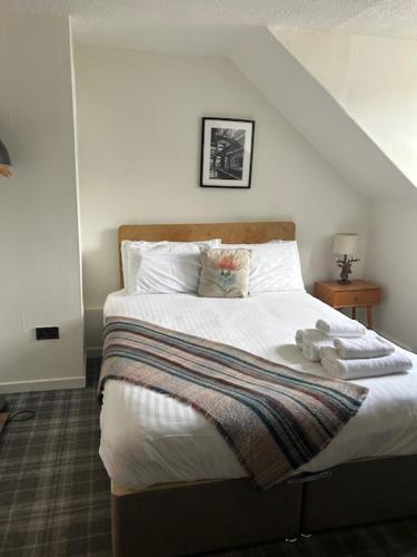 a bedroom with a bed with a teddy bear on it at Cardross Inn in Cardross