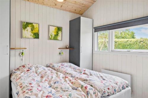 a bedroom with a bed and a window at OH285-Hadsund-Mollevaenget-19 in Hadsund
