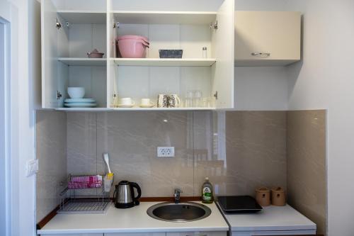 a kitchen with a sink and a counter top at Sienna Apartments Budva in Budva