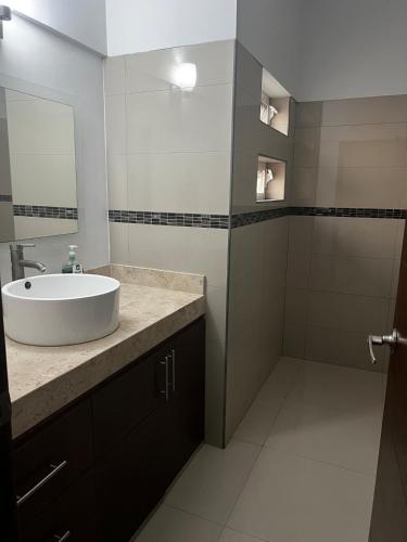 a bathroom with a sink and a shower at La Casa del Mar, Club Santiago with a private pool in Manzanillo