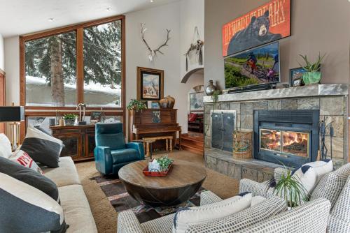 a living room with a fireplace and a couch at Luxury Home with Private Hot Tub, Woodburning Fireplace, Pet Friendly in Vail