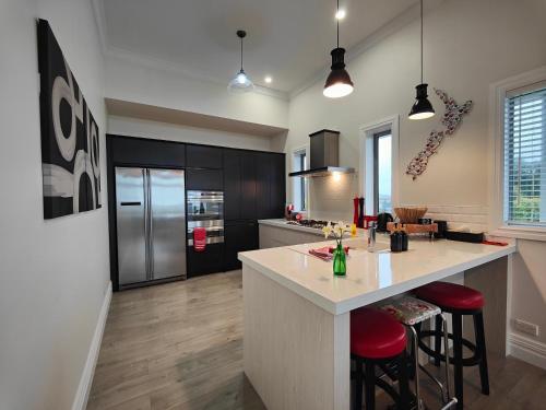 a kitchen with a large island with red bar stools at Church Street Charmer in Riverton